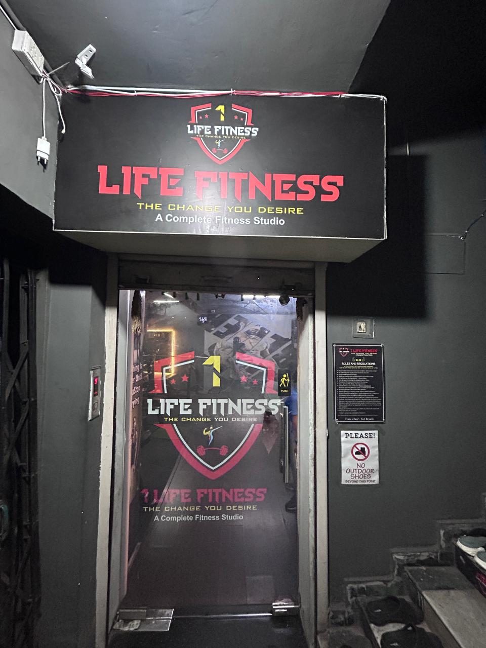 Entrance with the 1 Life Fitness shield on the glass door