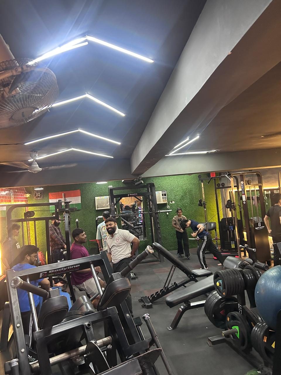 Members training under LED ceiling lights on the 1 Life Fitness floor