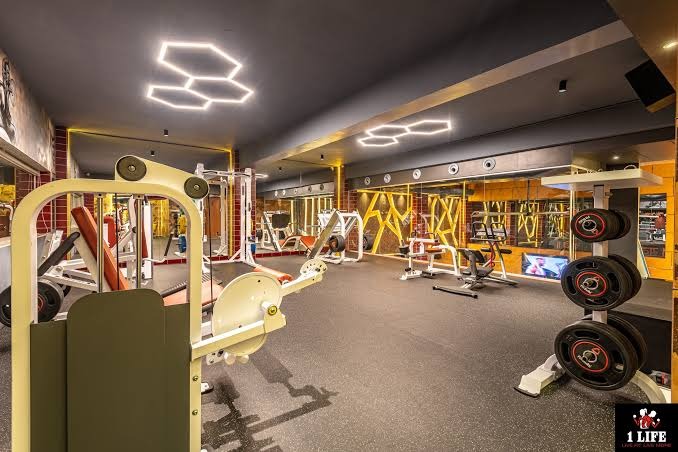 Gym floor with hexagon lights, mirrored walls and plate racks