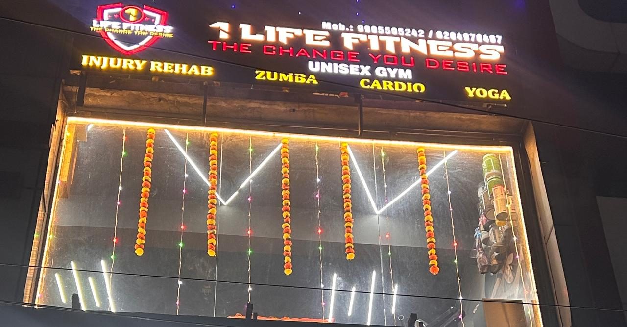 The lit-up 1 Life Fitness signboard: unisex gym, injury rehab, Zumba, cardio and yoga